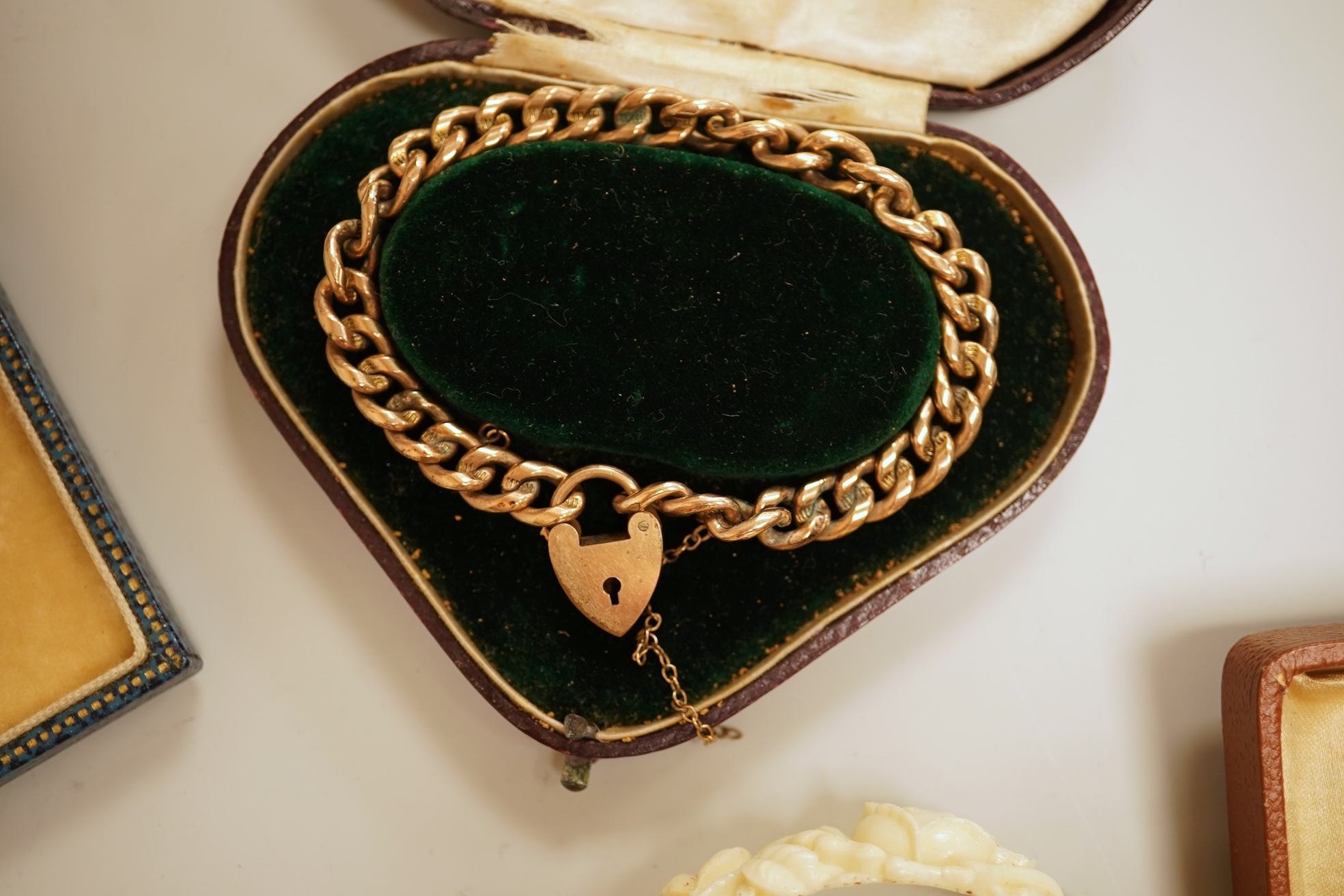A small group of assorted jewellery including a gold plated curb link bracelet, silver brooch, simulated pearl necklace and costume.